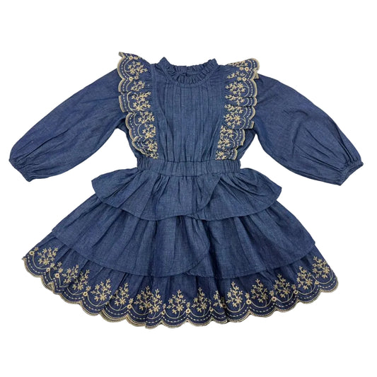 A vintage-style blue dress for girls featuring long puff sleeves, a ruffled high neck, and tiered skirt with gold floral embroidery and scalloped edges.