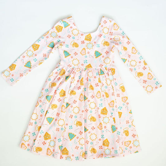 Children's dress with colorful gingerbread pattern on a white background
