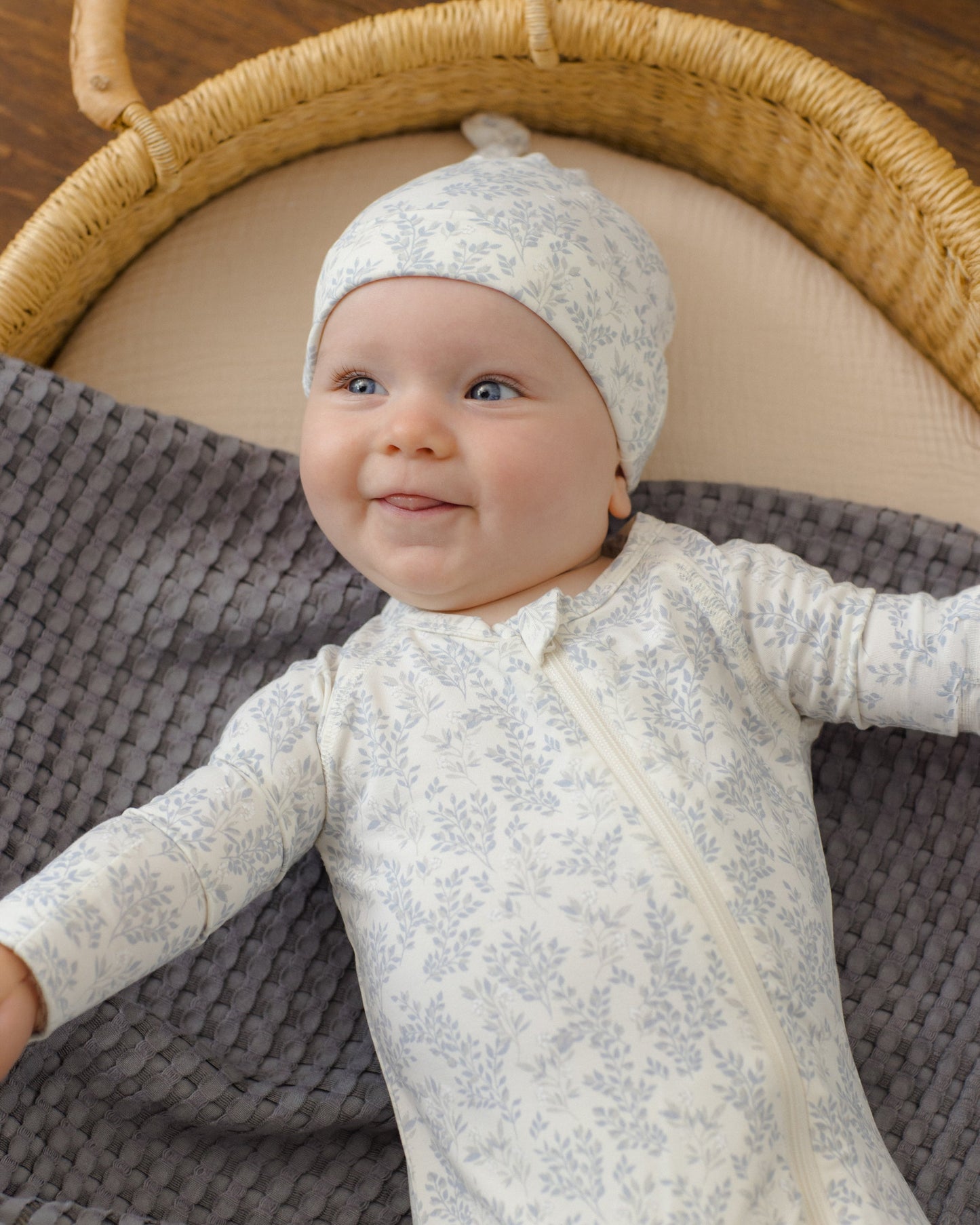 Cloud Floral Bamboo Zip Footie, lifestyle photo of baby
