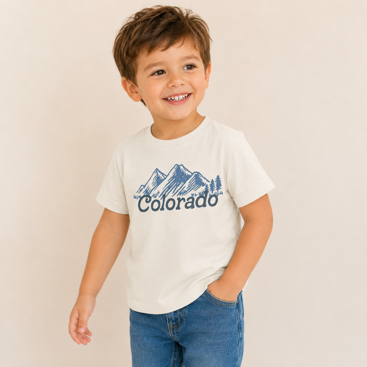 Child wearing a white t-shirt with 'Colorado' and mountain graphic.