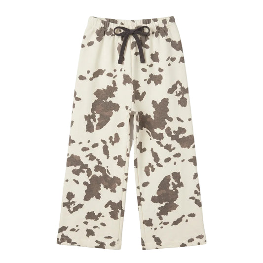 A pair of curtain panels with a black and off-white cow print pattern sweatpants