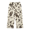 A pair of cropped sweatpants with a cow-print pattern in beige and dark gray, sweatpants 