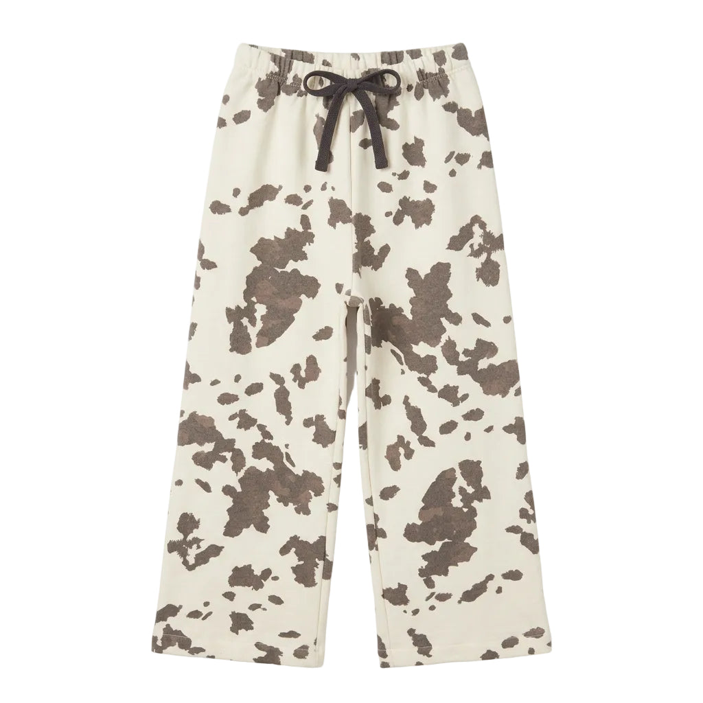 A pair of curtain panels with a black and off-white cow print pattern sweatpants