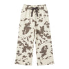 A pair of curtain panels with a black and off-white cow print pattern sweatpants
