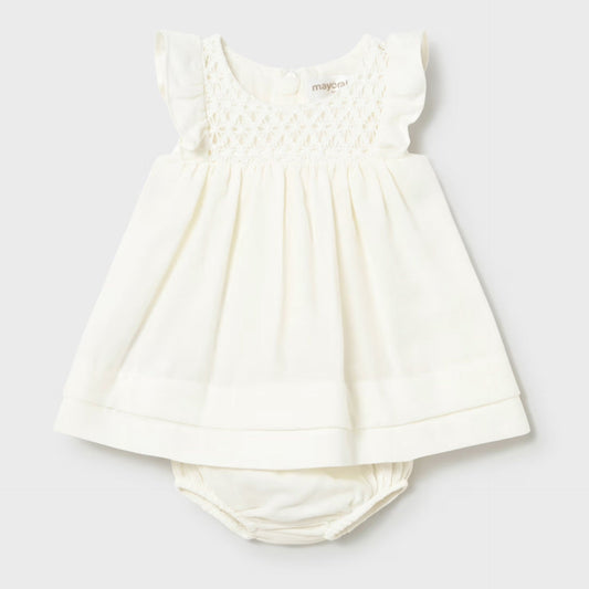 cream smocked dress with bloomer on a light gray background