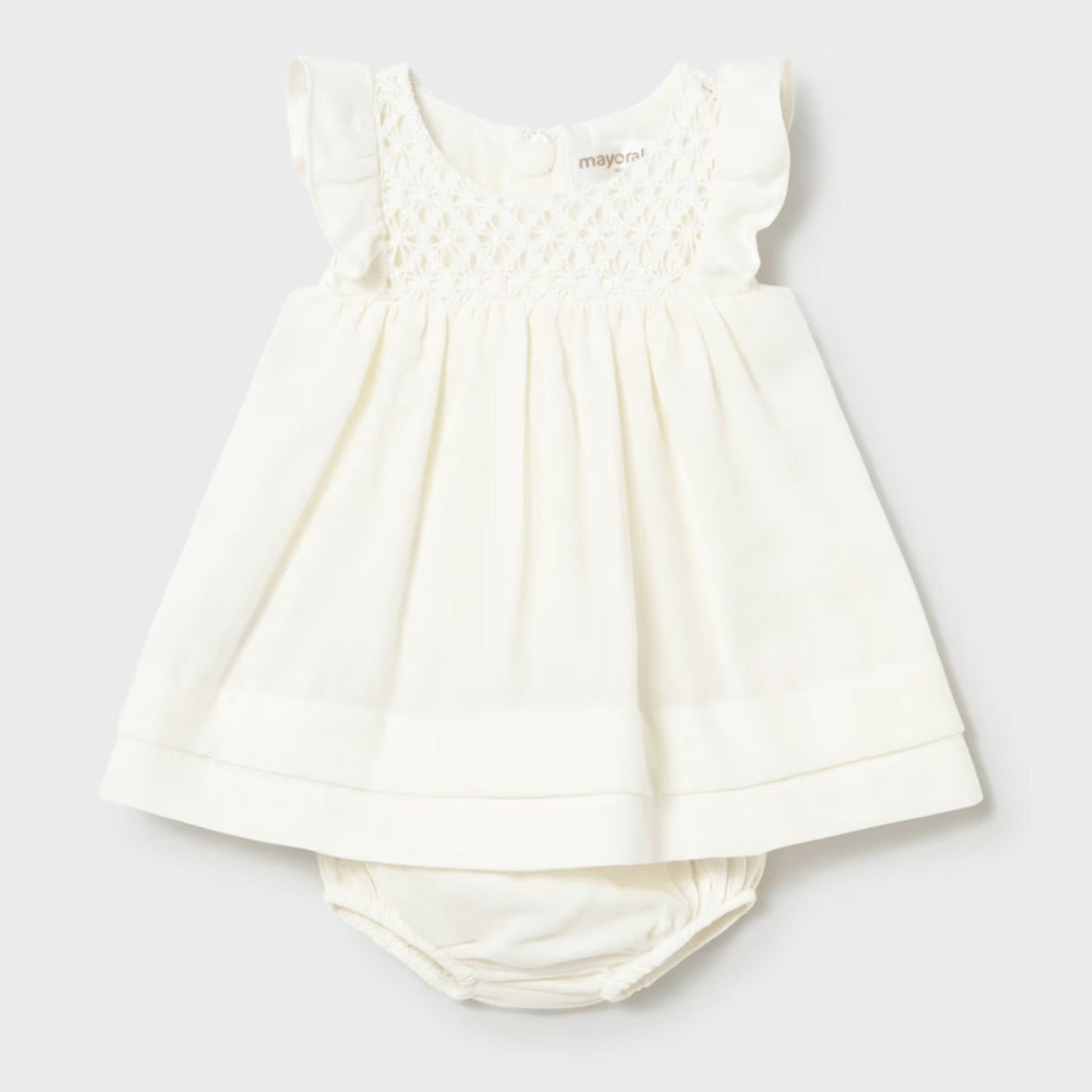 cream smocked dress with bloomer on a light gray background