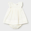 cream smocked dress with bloomer on a light gray background