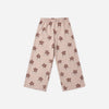 A pair of light pink track pants with an elastic waistband and an all-over flower pattern.