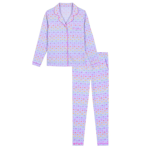 A two-piece pajama set featuring a long-sleeve button-up top and matching pants, both decorated with a repeating pastel pattern of colorful hearts on a light lavender background.