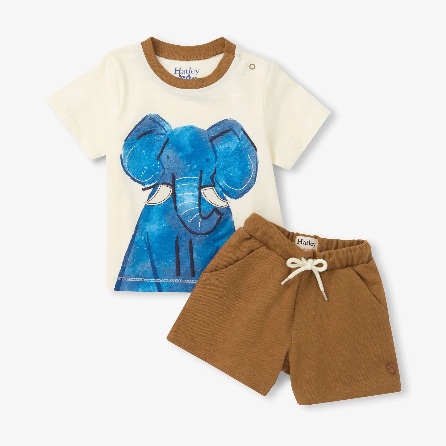 White tea with brown neck line and blue elephant graphic, with brown shorts that have a white tie 