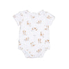 White baby onesie with brown and white dog print