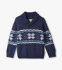 Blue sweater with snowflake pattern on a light gray background