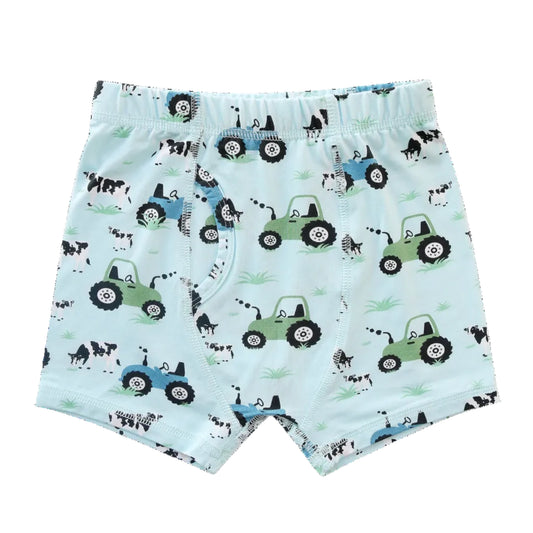 Children's boxer briefs with tractor and cow pattern on a light blue background