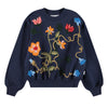 Navy blue sweater with colorful floral embroidery on a white background