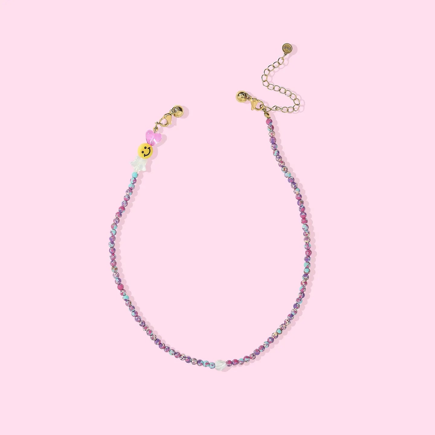 Beaded necklace with colorful beads on a pink background