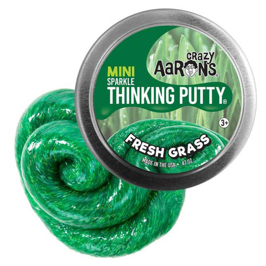 Green thinking putty with a container labeled 'Crazy Aaron's Thinking Putty Fresh Grass' on a white background.