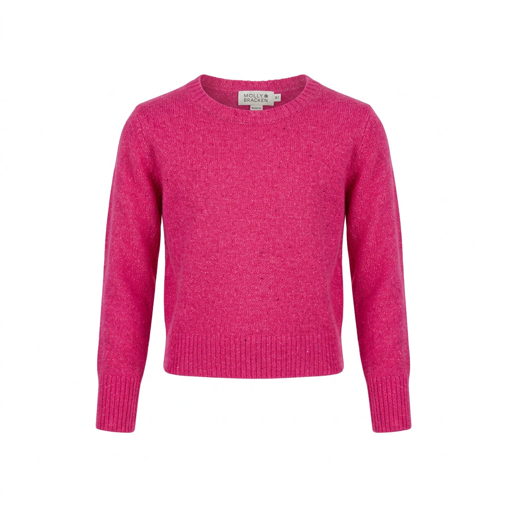 A bright pink cropped knit sweater with long sleeves, 