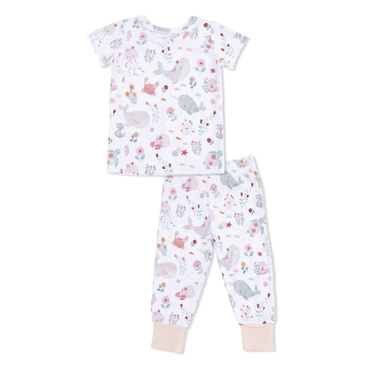 Children's pajama set with sea animals and floral pattern on a white background