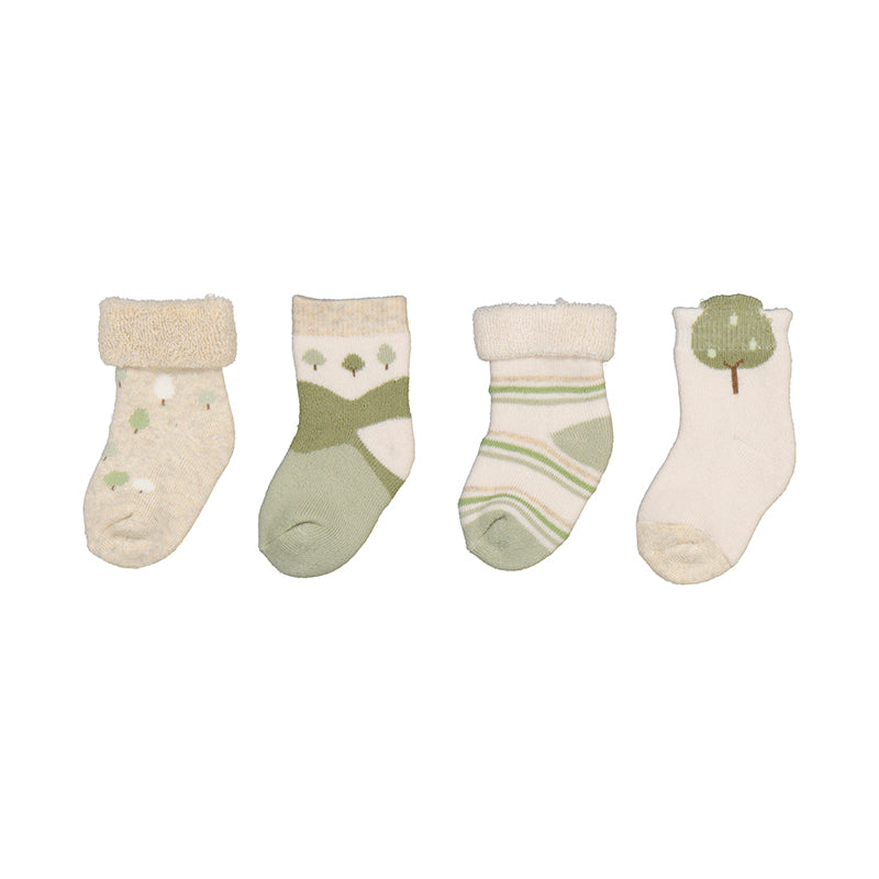 Set of four baby socks with green and beige patterns on a white background