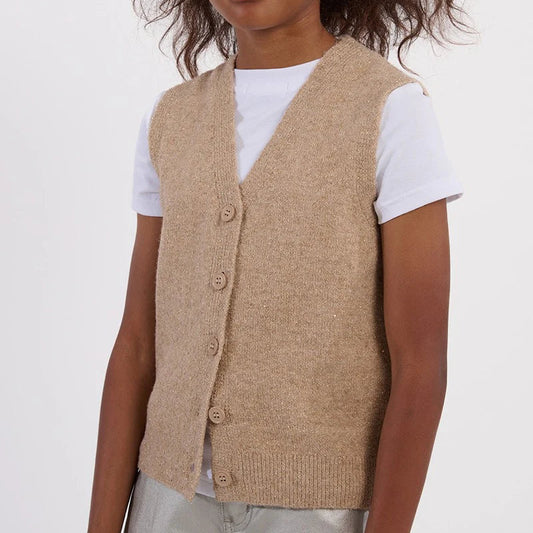Child wearing a beige vest over a white shirt on a plain background