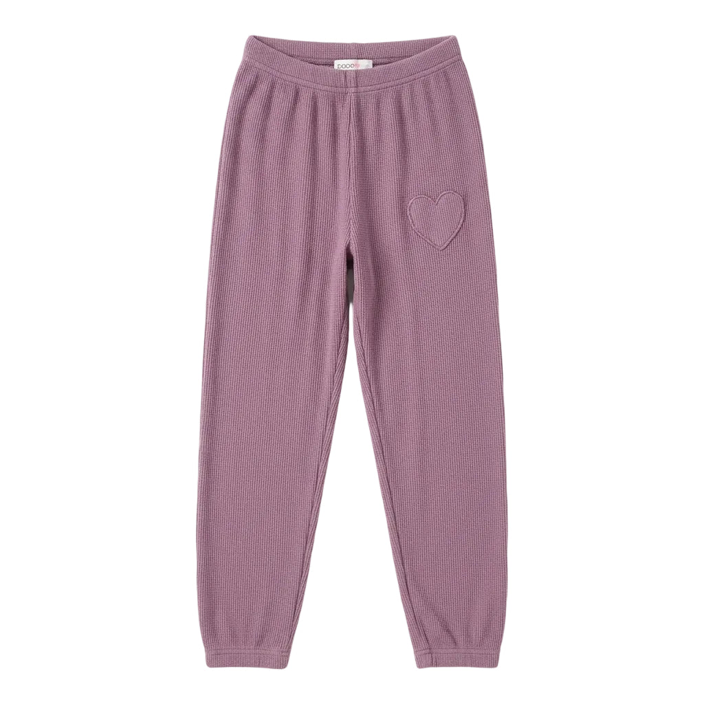 A pair of dusty purple sweatpants featuring a small heart-shaped patch on the upper left thigh.