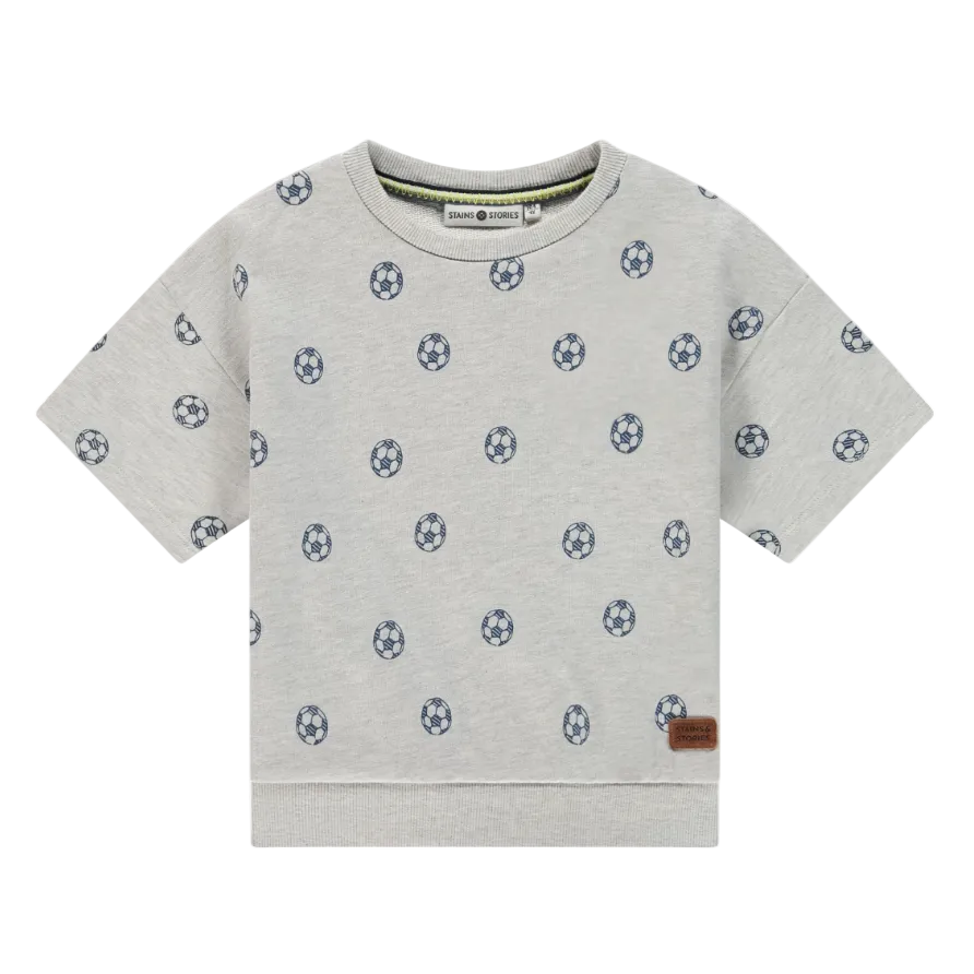 Gray t-shirt with soccer ball pattern on a white background