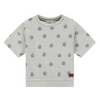 Gray t-shirt with soccer ball pattern on a white background