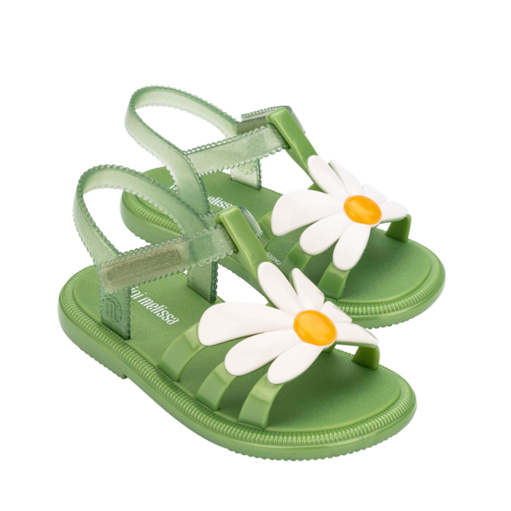 Green children's sandals with daisy flower designs on a white background