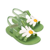 Green children's sandals with daisy flower designs on a white background