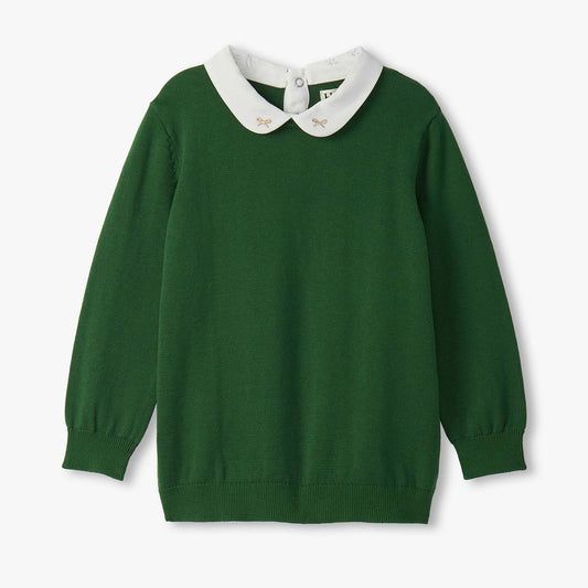 Green sweater with white collar on a light gray background