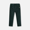 Dark green corduroy pants on a light gray background