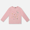 Pink long-sleeve shirt with floral designs on a light gray background