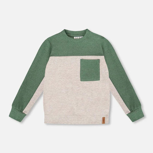 Green and beige long-sleeve shirt with a pocket on a light gray background