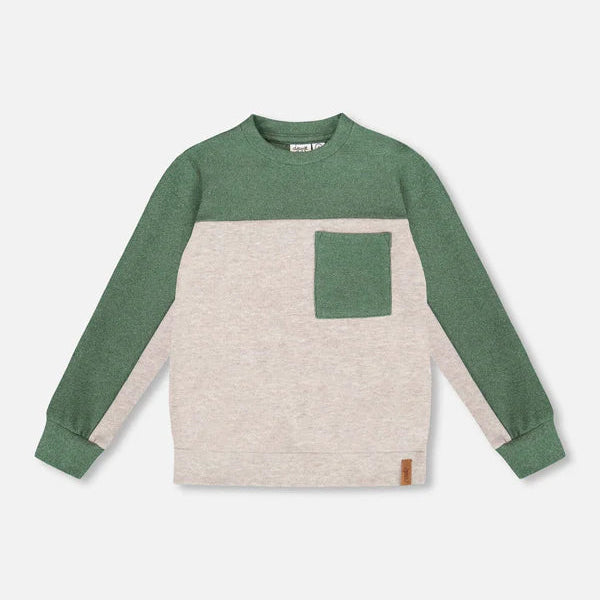 Green and beige long-sleeve shirt with a pocket on a light gray background