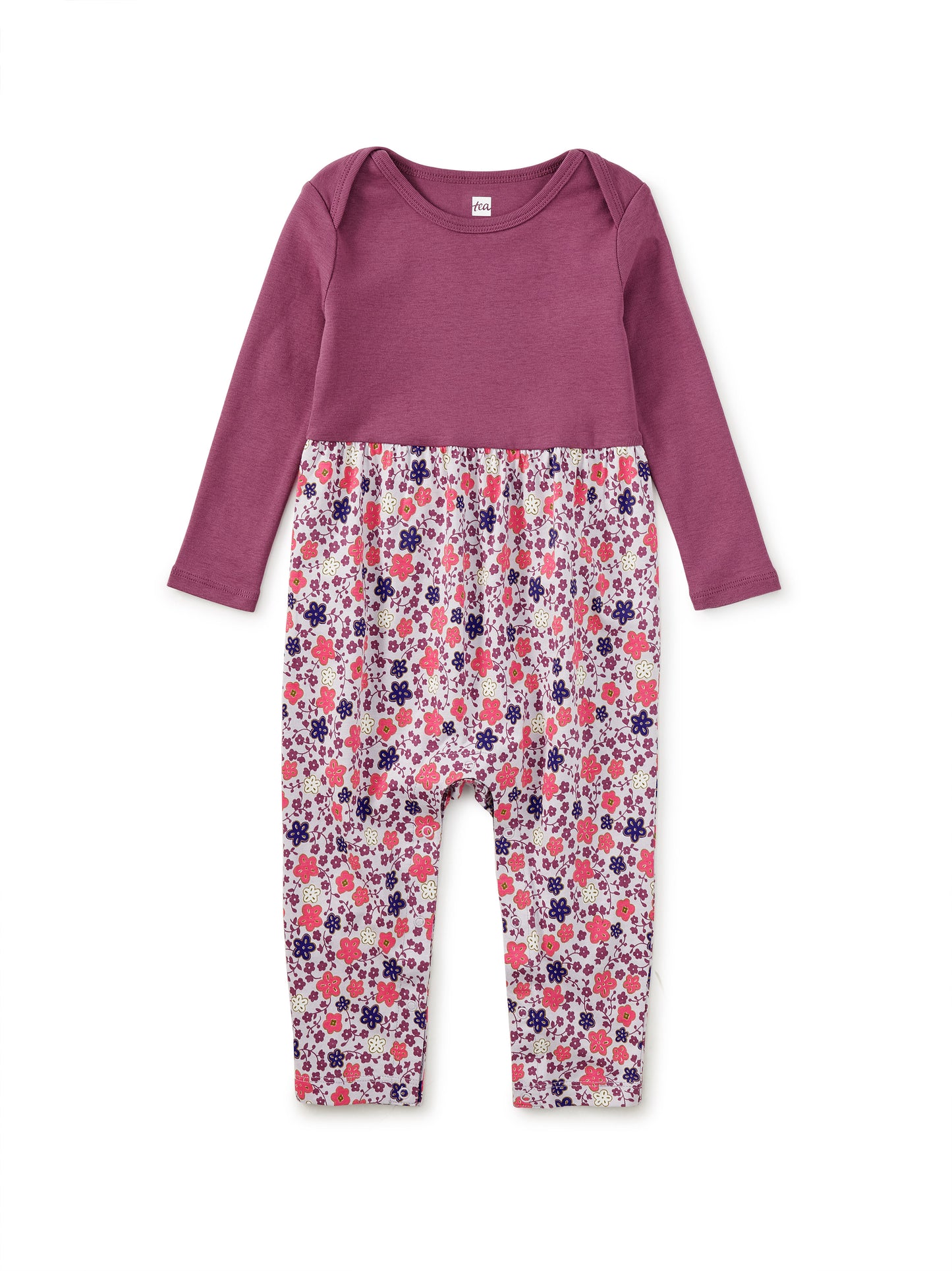 Purple top and floral pants set on a white background