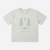 A light gray heather short-sleeve t-shirt with a dark gray graphic of two pine trees, a crescent moon, stars, and the text 'HAPPY PLACE' on the front, displayed flat against a light gray background.