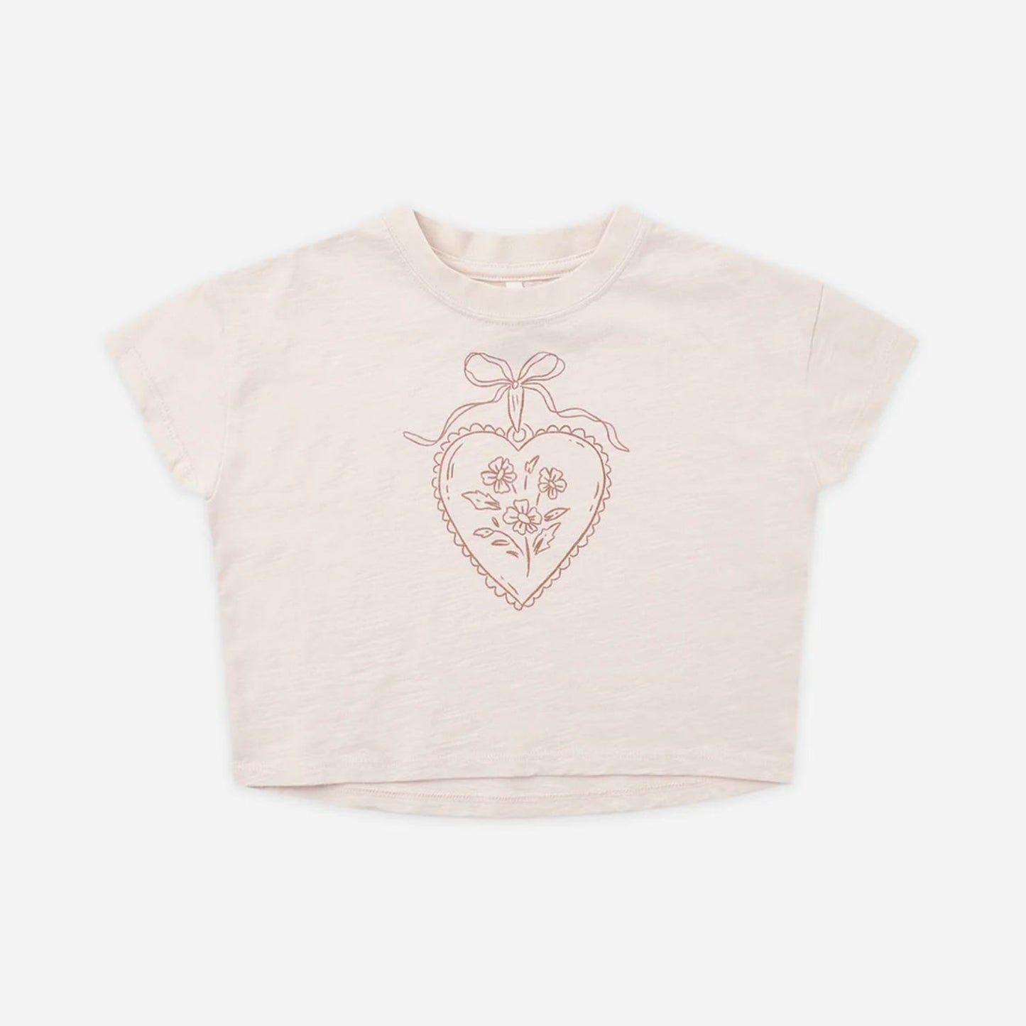 A light beige short-sleeve crop top with a rose gold glittery heart graphic on the chest.
