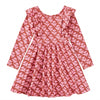 A long-sleeve children's dress with a ruffled neckline, featuring an all-over pink floral print on a terracotta brown background, laid flat against a white background.