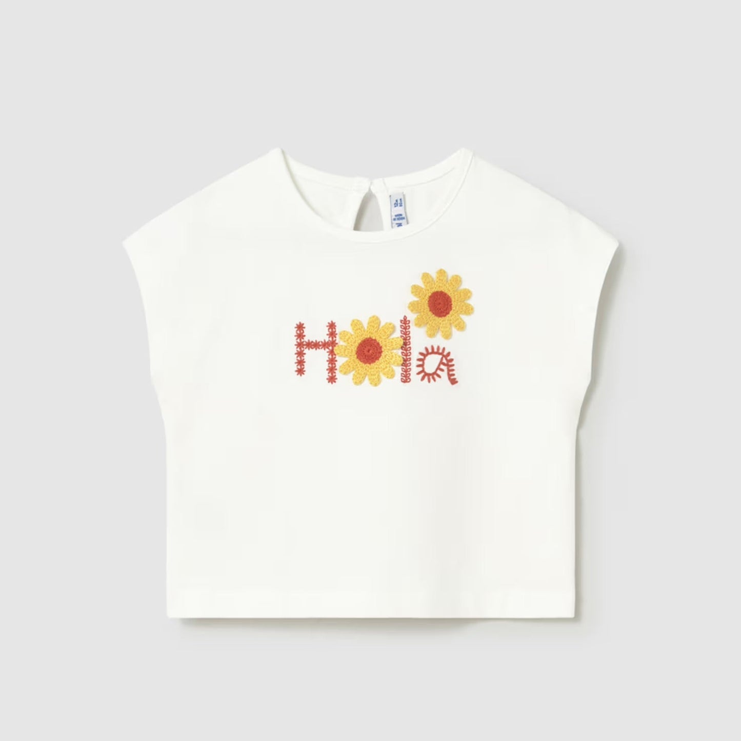 white top with the word 'hola' embroidered on it