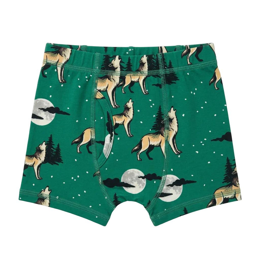 A pair of toddler boy's boxer briefs featuring a green forest pattern with howling wolves, pine trees, and full moons,