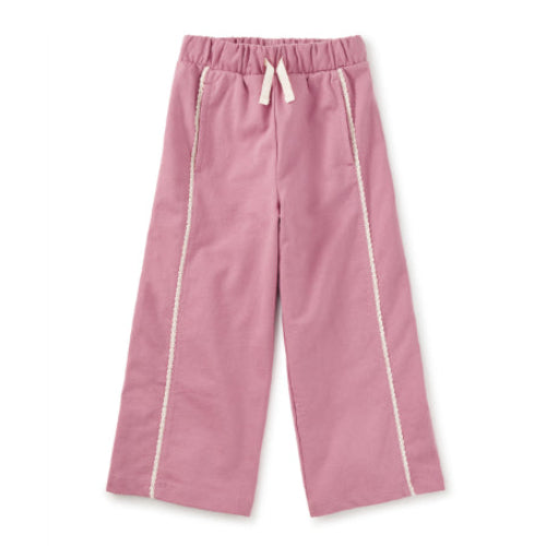 Pink pants with white trim on a white background