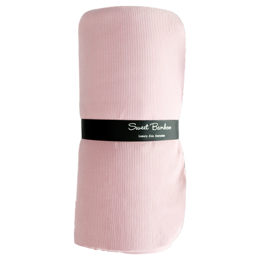 Pink fabric roll with a black label on a white background