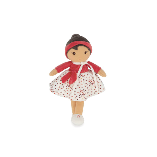 Doll with red outfit and white dress with red polka dots on a white background
