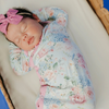Floral baby knotted gown with pink trim and snaps