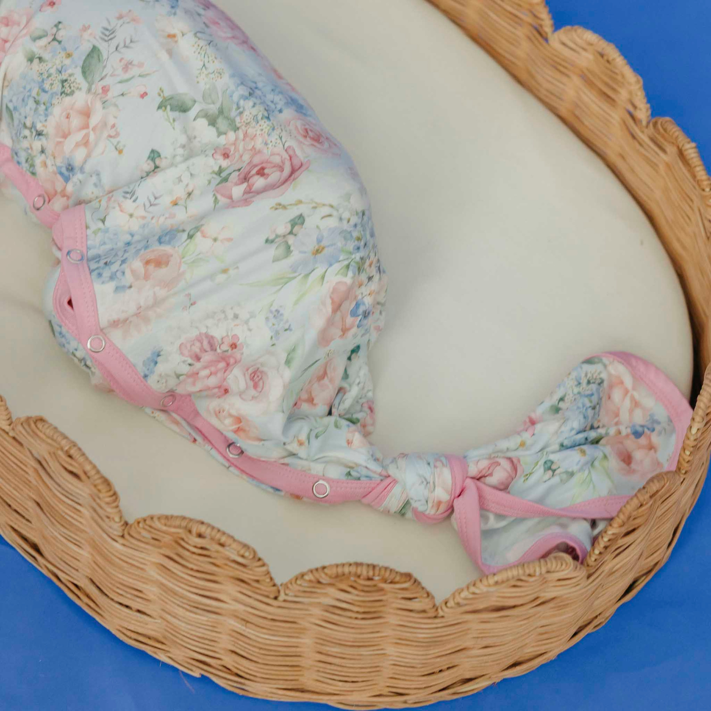 Floral baby knotted gown with pink trim and snaps