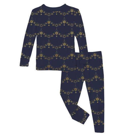 A navy blue two-piece pajama set for girls with a Christmas garland pattern.