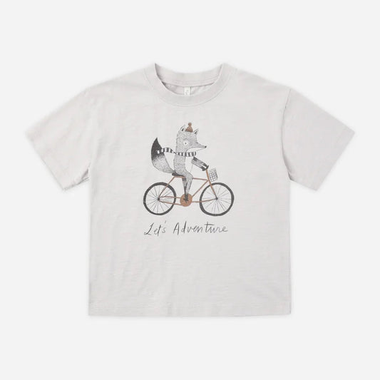 A light gray heathered short-sleeve t-shirt featuring a cartoon graphic of a fox riding a bicycle with the text 'Life Adventure' printed below, displayed flat against a light gray background.