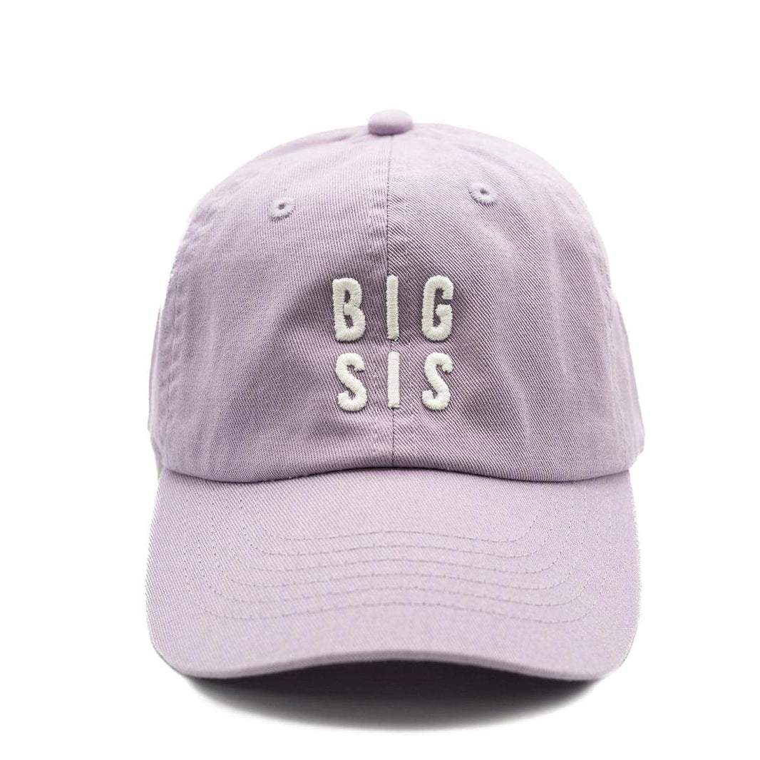A purple cap with the text 'BIG SIS' written on it in white letters.