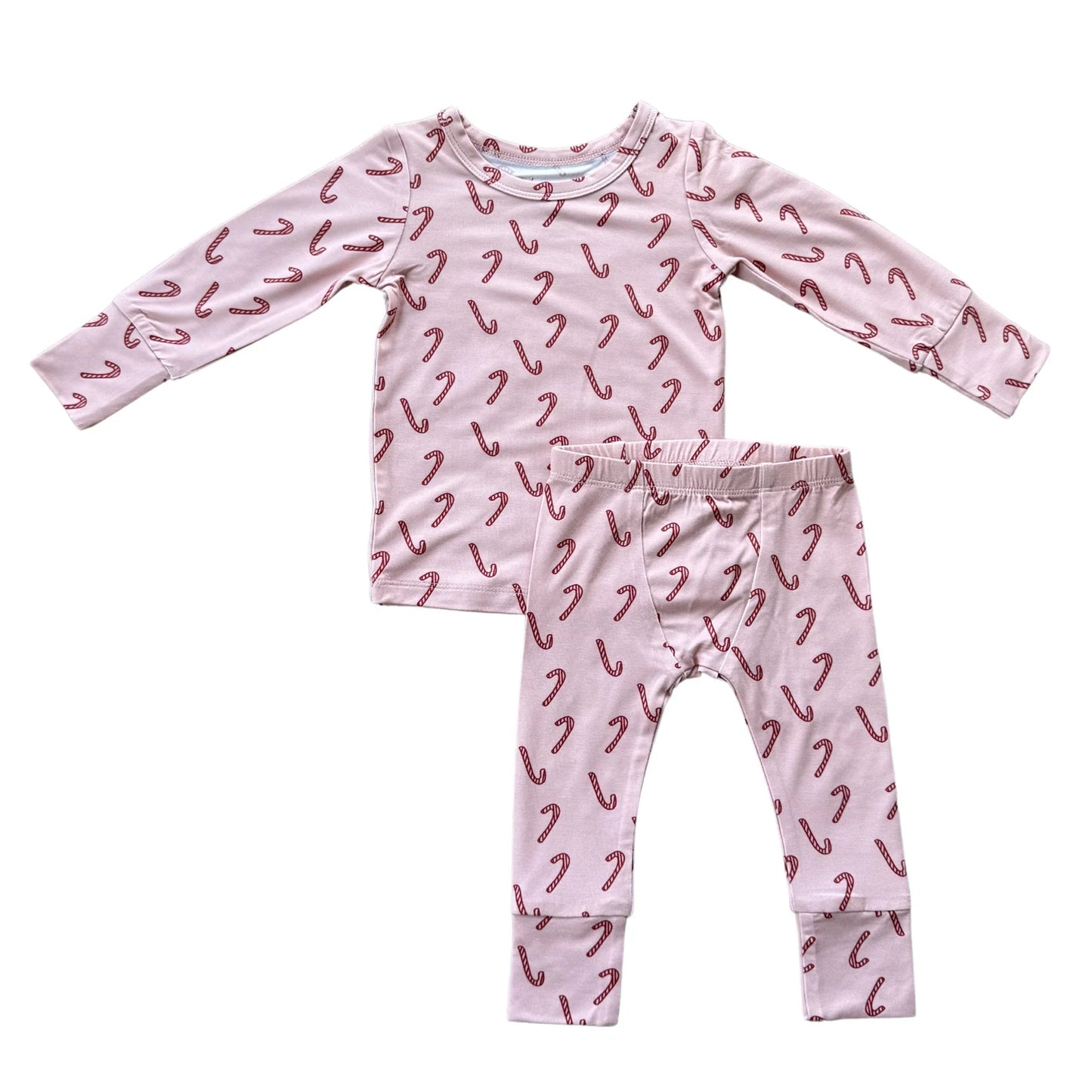 Children's pajama set with candy cane pattern on a white background