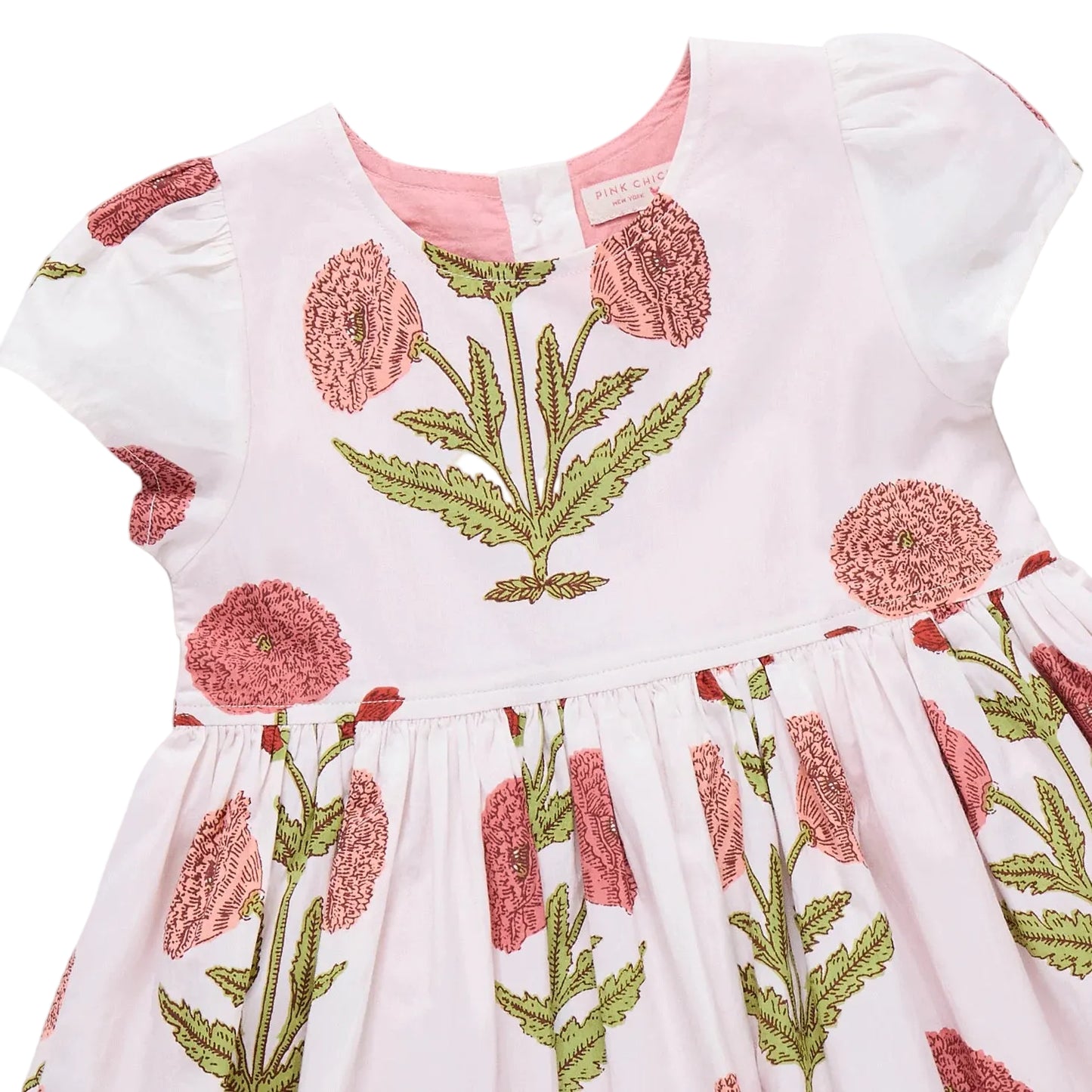 White dress with pink floral embroidery on a light gray background